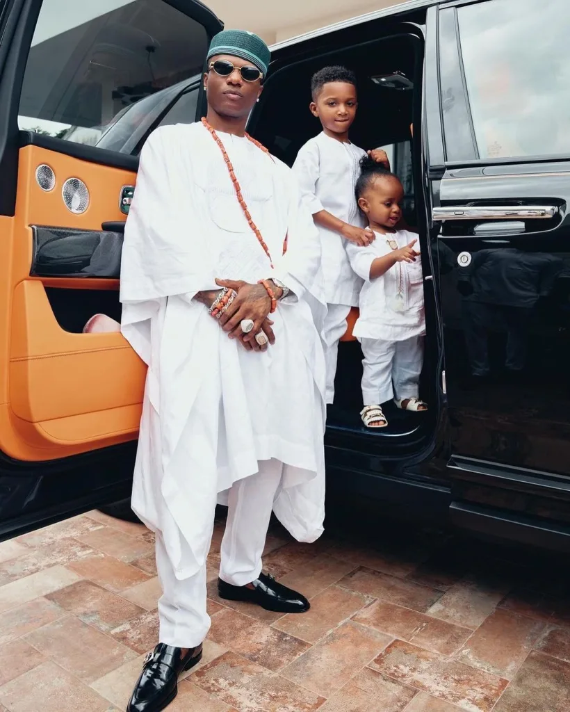 Wizkid and his children coming down from his rolls Royce his mom's funeral