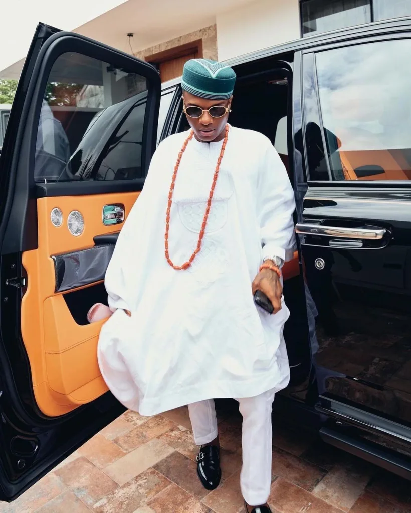 Wizkid coming down from his rolls rocyes his mom's funeral